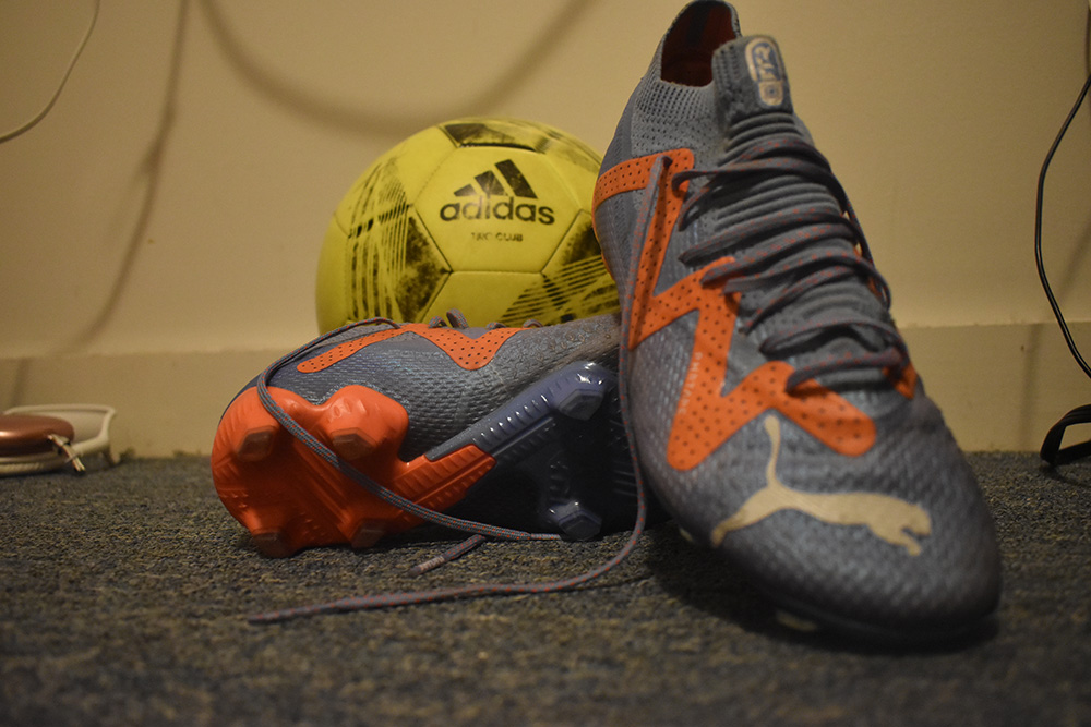 Soccer cleats next to ball