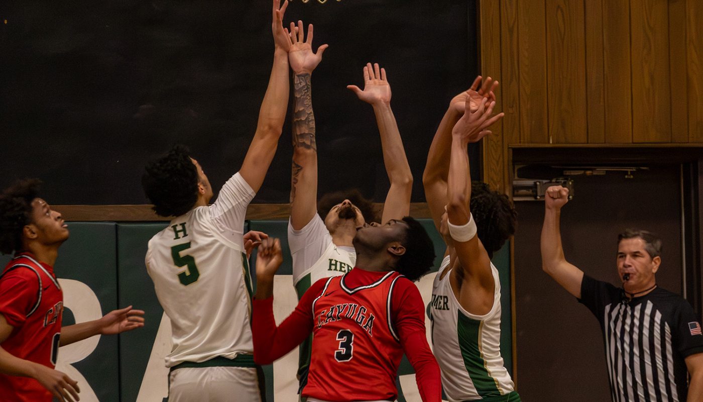 Basketball Players Jump for Ball