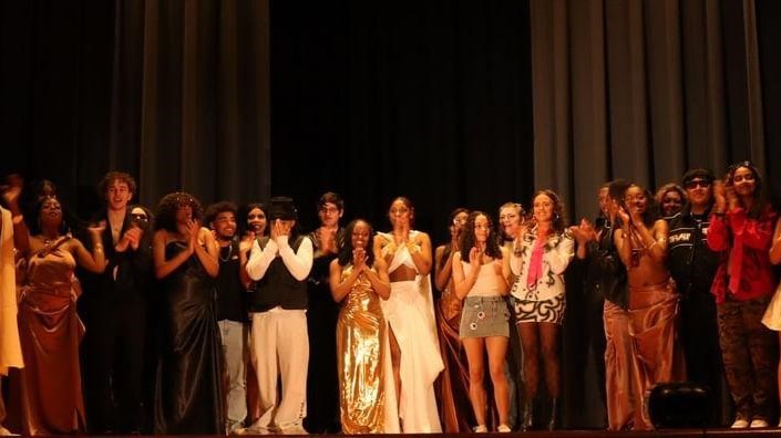 Group photo on stage from the 2024 Fashion Show.