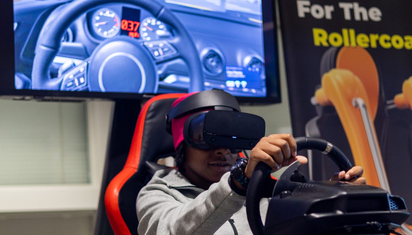A student sits in a driving simulator