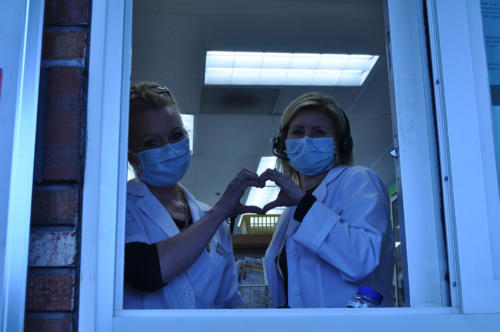Alexis G.This picture is my mom (Left) and another pharmacist Leslie (right) at work during this horrible pandemic.  This white balance is a little off on this picture but I actually like it because its very gloomy and we are in a very gloomy time so I actually like it. This affects me because my mom is an essential worker during these times and she is risking her life every day to help people. 
