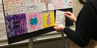 Woman places small artwork on easel