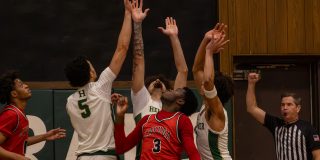 Basketball Players Jump for Ball