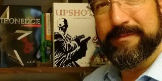 Author poses with books