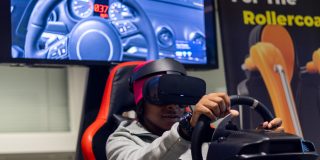 A student sits in a driving simulator